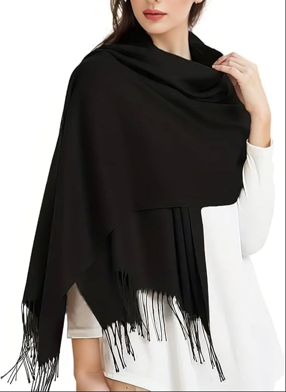 Woman wearing a black fringed scarf on a white background