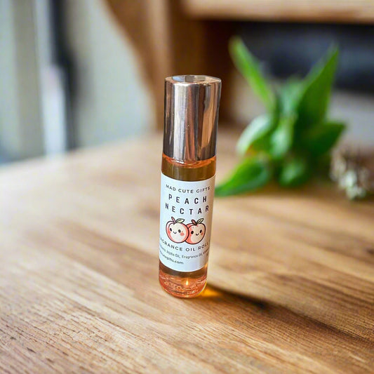 Small bottle of peach-flavored oil with a label on a reflective surface