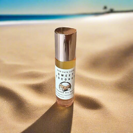 Roll-on bottle of Sweet Coconut oil on a beige surface