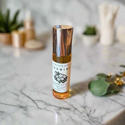 Small bottle of jasmine oil on a reflective surface
