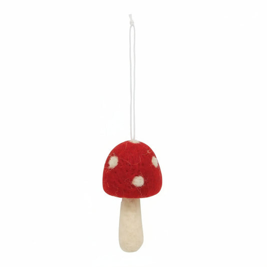 Red and white mushroom ornament hanging on a white background